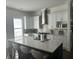 Modern kitchen with white cabinets, stainless steel appliances, and a large island at 1745 Thomas Dr, Hoschton, GA 30548