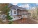 Exterior view of home featuring a screened-in back porch, surrounded by trees at 3075 Heather Stone Way, Lawrenceville, GA 30043