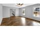 Living area with wood-look floors, a ceiling fan, and natural light from multiple windows at 3075 Heather Stone Way, Lawrenceville, GA 30043