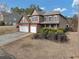 Two-story home with a two-car garage and landscaped yard, viewed from a slight angle at 300 Meadowwood Cir, Woodstock, GA 30188