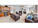 Living room with fireplace, built-in shelves, and brown leather furniture at 300 Meadowwood Cir, Woodstock, GA 30188