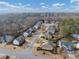 Residential neighborhood with two-story craftsman style houses with trees and clouded blue skies at 300 Meadowwood Cir, Woodstock, GA 30188