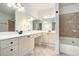 Spacious primary bathroom featuring double vanity, soaking tub, shower, and tile flooring at 3334 Peachtree Ne Rd # 908, Atlanta, GA 30326