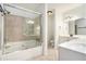Modern bathroom with a glass-enclosed shower/tub combo, tile walls, and white vanity at 3334 Peachtree Ne Rd # 908, Atlanta, GA 30326