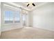Bright bedroom with carpeted floors, large windows with shutters, and balcony access at 3334 Peachtree Ne Rd # 908, Atlanta, GA 30326