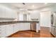 Modern kitchen featuring stainless steel appliances, white cabinetry, and granite countertops at 3334 Peachtree Ne Rd # 908, Atlanta, GA 30326