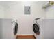Laundry room with a front-loading washer and dryer, wire shelving, and linoleum flooring at 3334 Peachtree Ne Rd # 908, Atlanta, GA 30326
