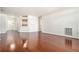 Open living room with hardwood floors and access to the kitchen and hallway at 3334 Peachtree Ne Rd # 908, Atlanta, GA 30326