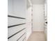 Large walk-in closet with white built-in shelving and drawers, and carpeted flooring at 3334 Peachtree Ne Rd # 908, Atlanta, GA 30326