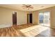 Spacious bedroom with wood-look laminate floors, ceiling fan, and ensuite bathroom at 562 Dickens Nw Rd, Lilburn, GA 30047