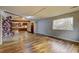 Living room with wood floors and large windows offering natural light at 562 Dickens Nw Rd, Lilburn, GA 30047