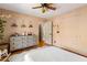 bedroom with hardwood floors and soft pink walls, ceiling fan and dresser at 2624 Whiteleigh Ne Dr, Atlanta, GA 30345