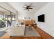 Cozy living room with white couch, wood floors, ceiling fan, and access to the sunroom at 2624 Whiteleigh Ne Dr, Atlanta, GA 30345