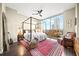 Spacious main bedroom with city views, a four-poster bed, and a cozy sitting area at 2795 Peachtree Ne Rd # 1009, Atlanta, GA 30305