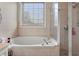 Bathroom featuring a corner soaking tub and shower at 1012 Inca Ln, Woodstock, GA 30188