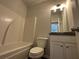 Bathroom with tub/shower combo, granite vanity, and white cabinetry at 5110 Black Bear Trl, Douglasville, GA 30135