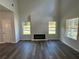 Living room with dark wood-look floors and large windows at 5110 Black Bear Trl, Douglasville, GA 30135