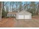 Gray house with double garage and mature trees at 1805 River Rock Trl, Woodstock, GA 30188