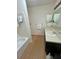 Bathroom with a shower/tub combo, vanity sink, and light wood-look flooring at , Roswell, GA 30076