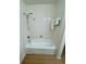 Clean bathroom with white tiled shower and wood-look flooring at , Roswell, GA 30076
