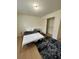 Simple bedroom featuring wood-look flooring, a spacious closet, and plush rug at , Roswell, GA 30076