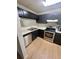 Kitchen with dark cabinets, stainless steel appliances, and light countertops at , Roswell, GA 30076