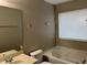 Bathroom with soaking tub, single vanity, and neutral-toned finishes at 113 Ellis Dr, Conyers, GA 30012