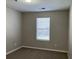 Simple bedroom with carpet and a large window at 113 Ellis Dr, Conyers, GA 30012