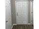 Inviting foyer with a six-panel door and wood-look flooring at 113 Ellis Dr, Conyers, GA 30012