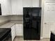 Updated kitchen with a sleek black refrigerator with water and ice dispenser at 113 Ellis Dr, Conyers, GA 30012