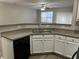 Kitchen features ample counter space, a double sink, and a dishwasher at 113 Ellis Dr, Conyers, GA 30012