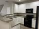 Modern kitchen with white cabinets, dark appliances, and granite counters at 113 Ellis Dr, Conyers, GA 30012