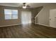 Spacious living room with wood-style flooring, ceiling fan, and sliding glass door at 113 Ellis Dr, Conyers, GA 30012