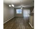 Spacious living room with wood-look flooring, ceiling fan, and sliding glass doors at 113 Ellis Dr, Conyers, GA 30012