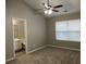 Spacious main bedroom with carpet, ceiling fan, and ensuite bathroom at 113 Ellis Dr, Conyers, GA 30012