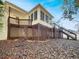 A spacious backyard with a large, elevated deck, sunroom, and trees at 125 Cedars Glen Cir, Villa Rica, GA 30180