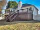 Backyard view of two-story house with a large deck and sunroom at 125 Cedars Glen Cir, Villa Rica, GA 30180