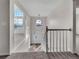 View of the foyer with a chandelier, white railing, and carpeted stairs at 125 Cedars Glen Cir, Villa Rica, GA 30180