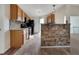 Updated kitchen featuring oak cabinets, black appliances, and tile flooring at 125 Cedars Glen Cir, Villa Rica, GA 30180