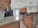 Kitchen boasts granite countertops, stainless steel appliances, and oak cabinetry at 125 Cedars Glen Cir, Villa Rica, GA 30180