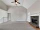 Living room with vaulted ceilings, a fireplace, and neutral-colored carpet at 125 Cedars Glen Cir, Villa Rica, GA 30180