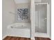 Modern main bathroom with a soaking tub, separate shower, and window view at 125 Cedars Glen Cir, Villa Rica, GA 30180
