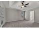 Spacious main bedroom with a ceiling fan, tray ceiling, and access to a private balcony or patio at 125 Cedars Glen Cir, Villa Rica, GA 30180