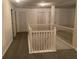 Spacious upper hallway with gray carpet and white railings at 3971 Busby Mill Ct, Ellenwood, GA 30294