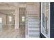 Bright foyer with a black door and wooden staircase at 52 Homesite Blair Grove Ct, Hampton, GA 30228