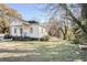 Side yard view of charming white cottage at 6515 James B Rivers Memorial Dr, Stone Mountain, GA 30083