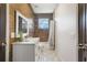 Modern bathroom with wood-like tile, white vanity, and patterned floor at 2119 Glendale Dr, Decatur, GA 30032