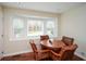 Bright breakfast room features a wood table and leather chairs, overlooking the backyard at 3492 Ember St, Marietta, GA 30066