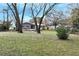 Large backyard with mature trees and partial view of home at 4251 Hamilton Mill Rd, Buford, GA 30519