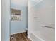 Clean bathroom with white shower/tub and wood-look floors at 4251 Hamilton Mill Rd, Buford, GA 30519
